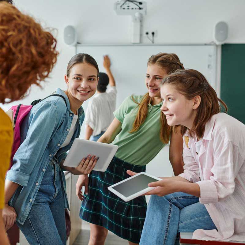 lp smiling teen schoolgirls holding digital tablets